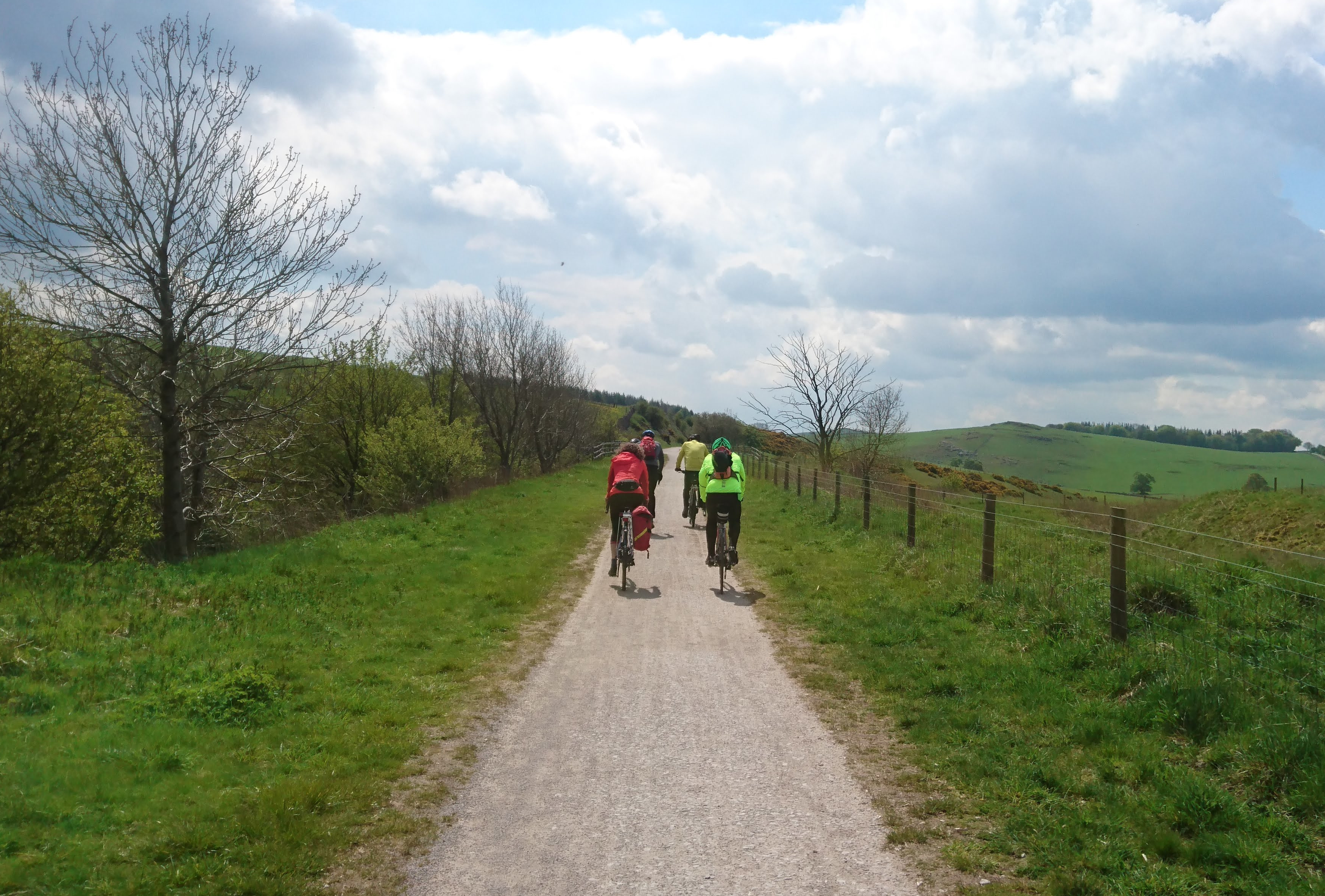 Group of cyclist heading along a country lane in the White Peak
