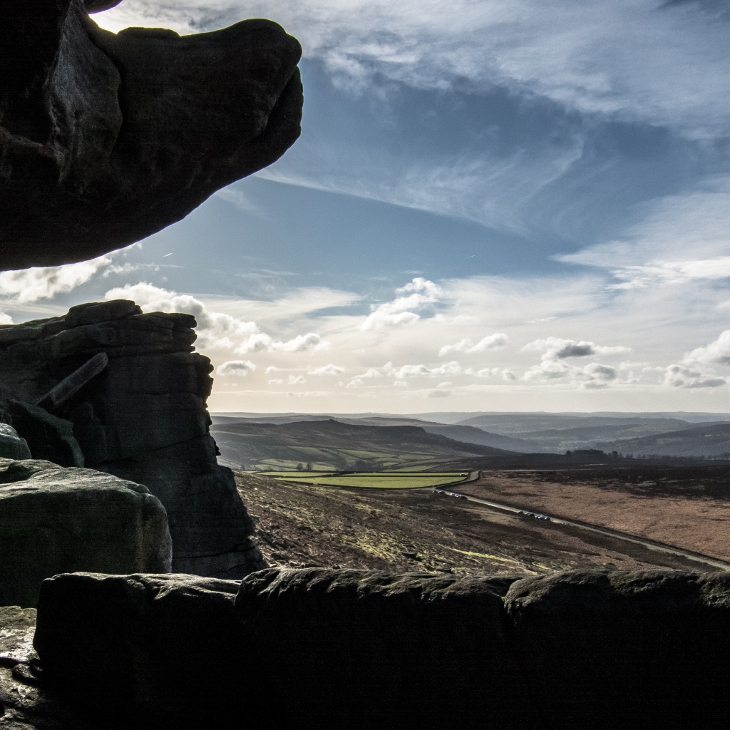 A view out over Stanage Edge from inside Robin Hoods Cave